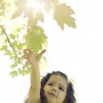 Girl Reaching for a Leaf